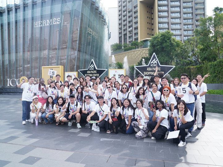 Students on a past EARC outing, group photo in front of a shopping plaza
